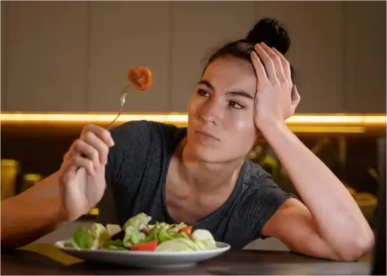 what cause arfid? | girl looking at food in wonder