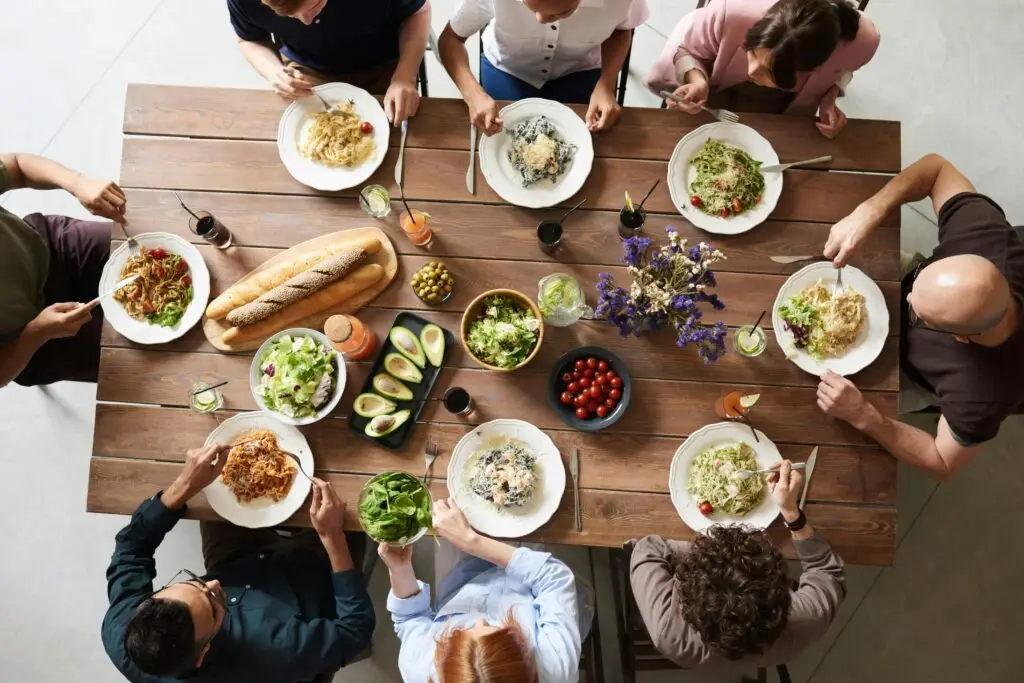 People eating dinner with a selection of food that would trigger many ARFID sufferers